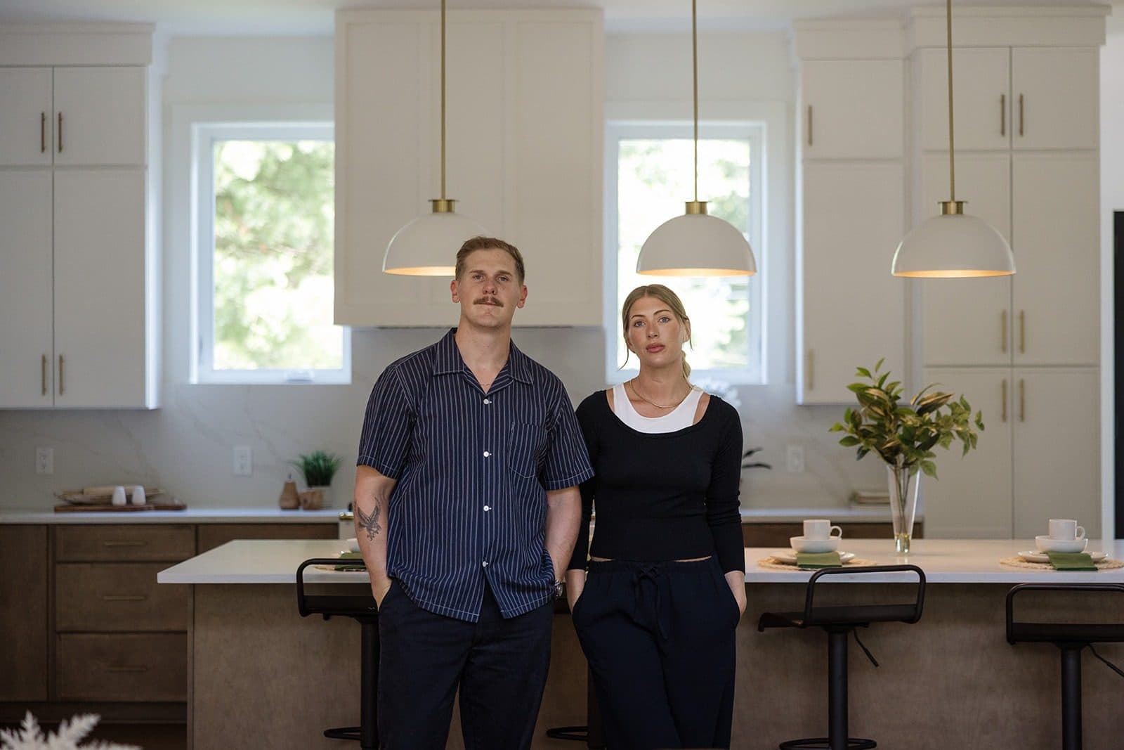 Ryan and Cassie Boggs standing at the island of a luxury kitchen