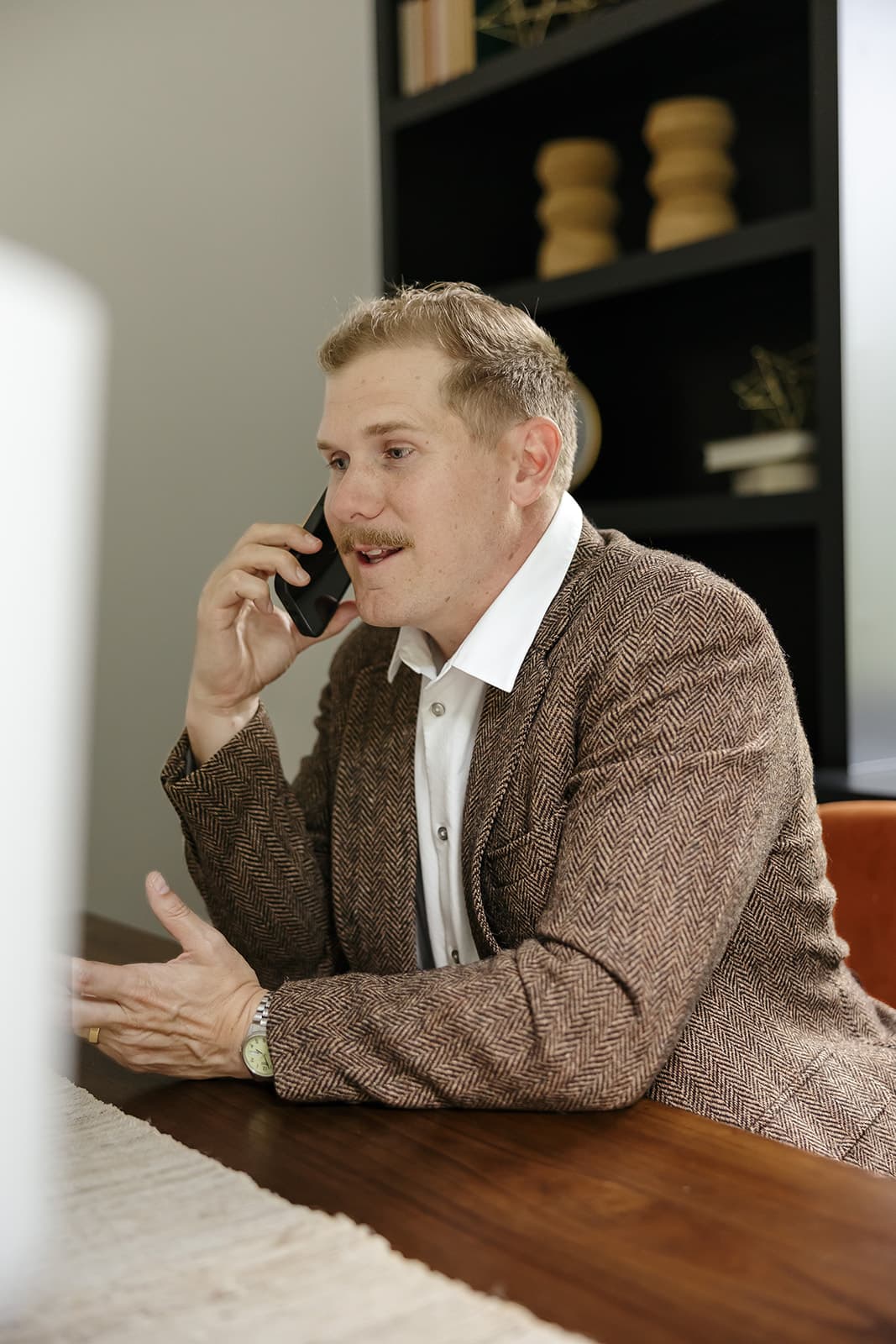 Ryan Boggs on the phone at a desk, mid-conversation
