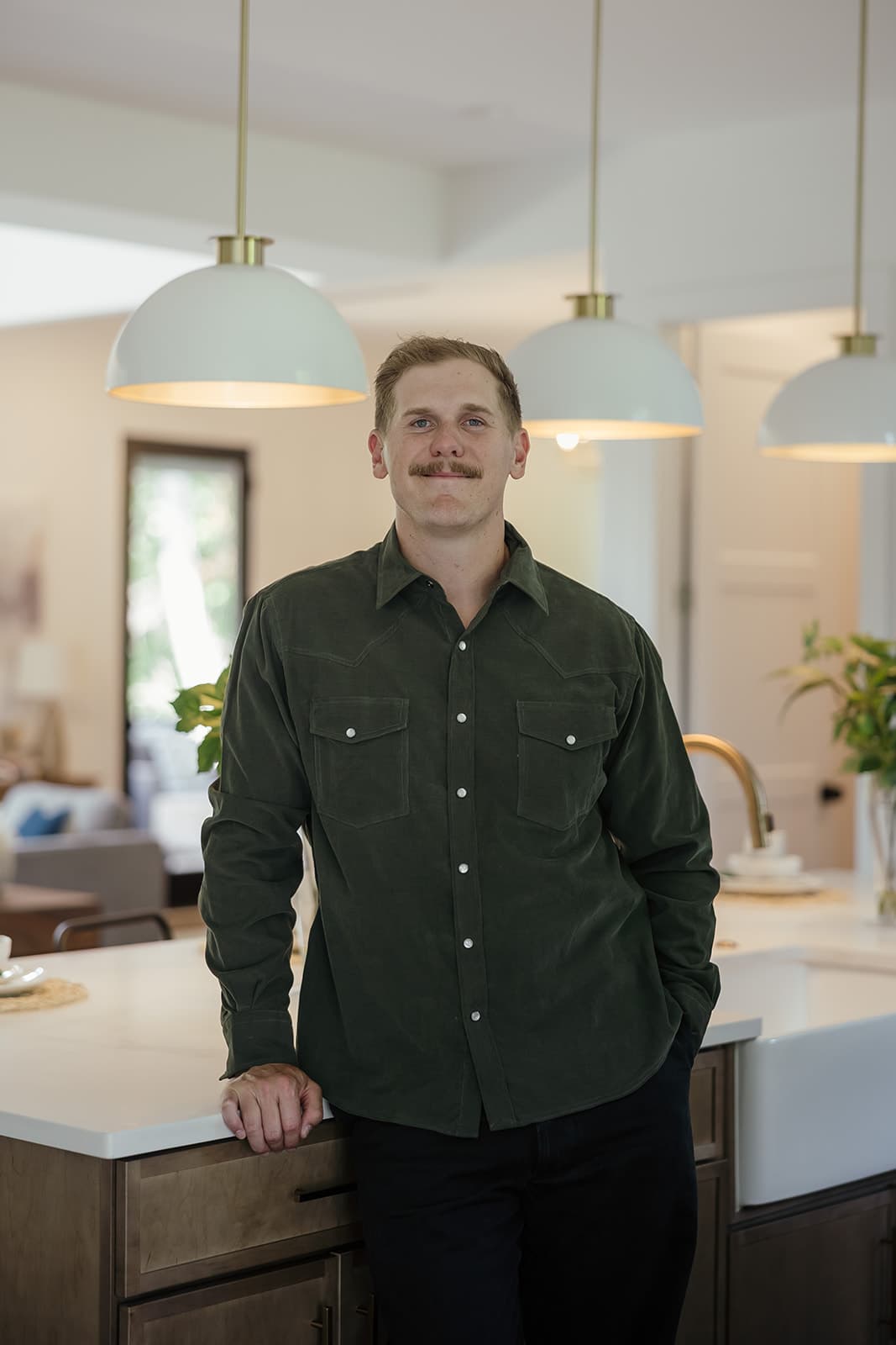 Ryan Boggs leaning against a kitchen island in a Williamson County home