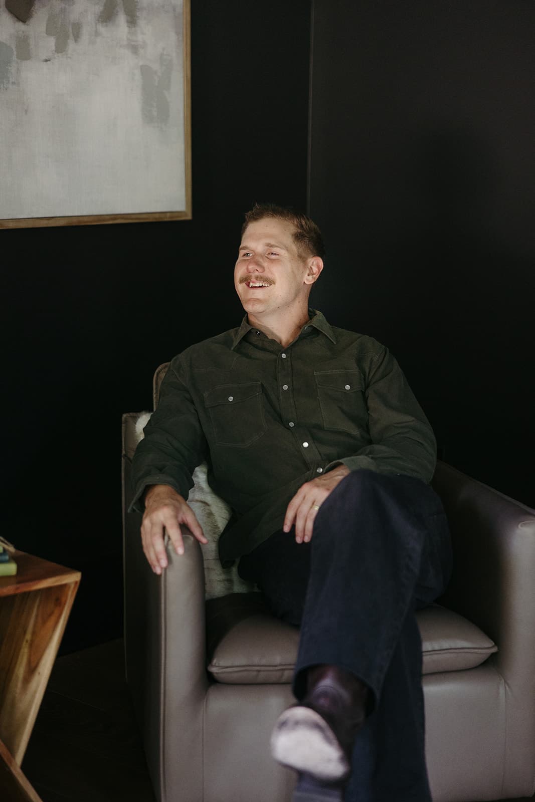 Ryan Boggs laughing candidly in a lounge chair