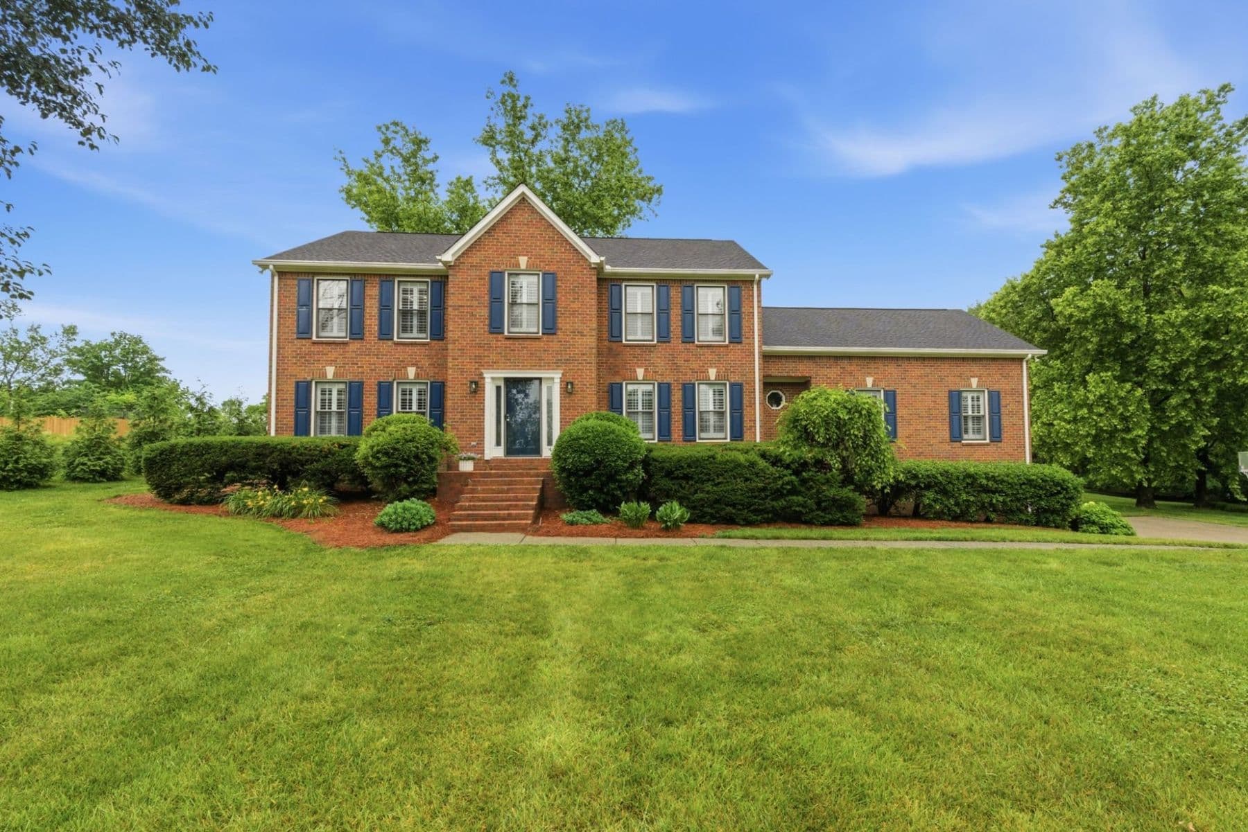 Sold: brick colonial with navy shutters on a large lawn in Williamson County